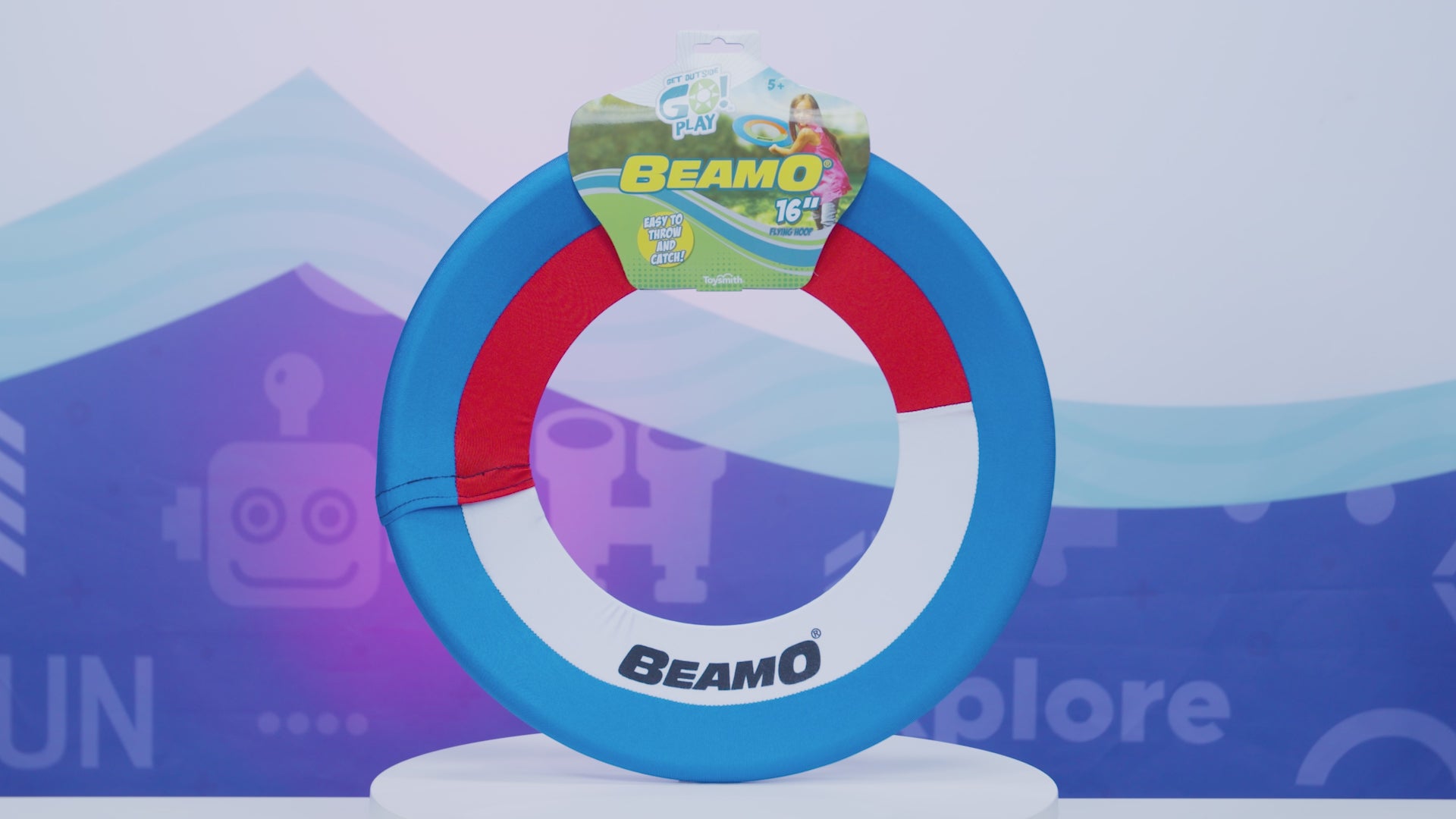 Video displaying Beamo disk and showing a young boy catching and throwing the Beamo disk outside. Tag states the disk is a foam ring made with soft fabric.