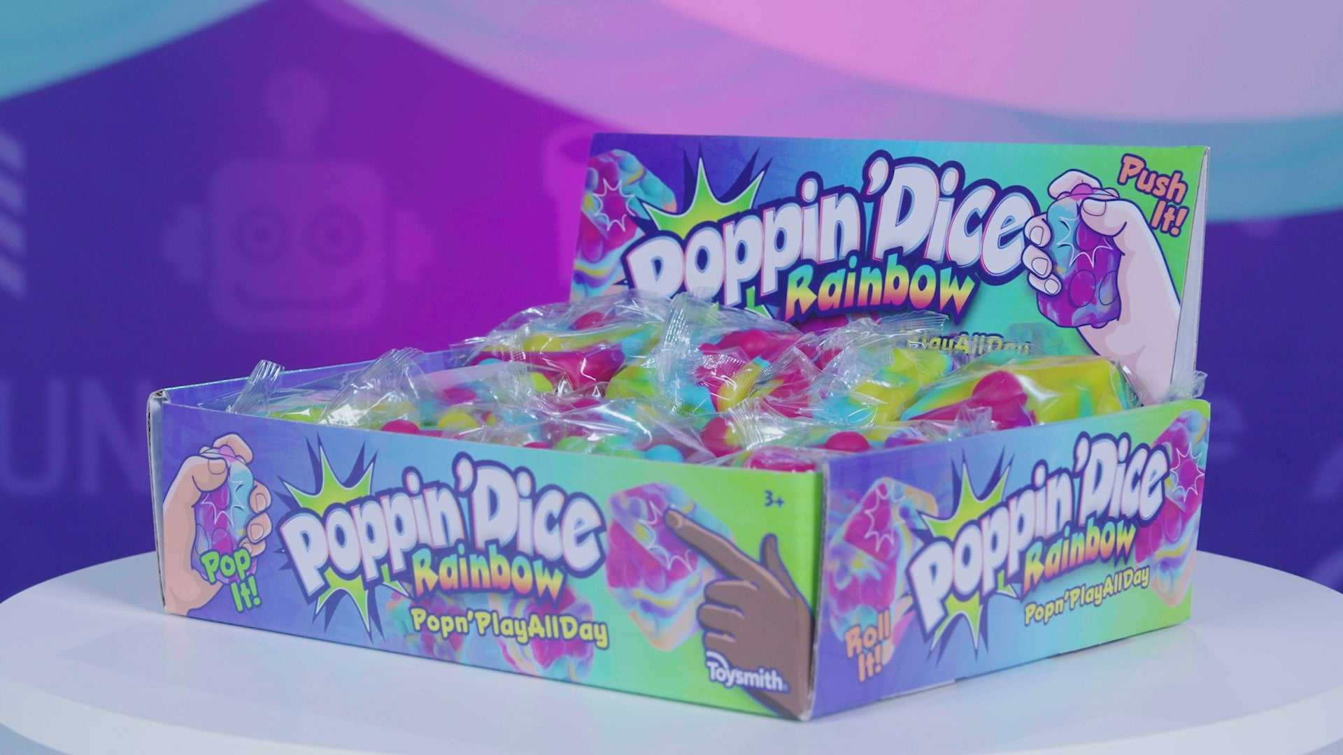 A video showing rainbow poppin' dice in packaging and in use